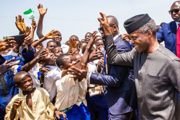 Acting President, Prof. Yemi Osinbajo waving school children in Kebbi state