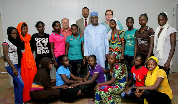 Founder of American University of Nigeria (AUN) Yola, Atiku Abubakar in a group photograph with the 15 abducted Chibok girls who escaped from Boko Haram custody, and were recently awarded scholarships to study at the AUN Academy in Yola, Adamawa State on Tuesday