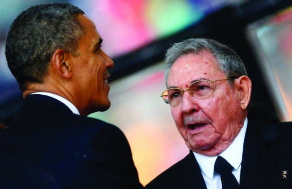File photo: US President, Barack Obama shaking hand with Cuba President, Raul Castro during memorial service of late South African leader, Nelson Mandela