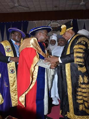 The Chancellor of Igbinedion University, Okada, Sir Gabriel Igbinedion congratulating the FCT Minister, Senator Bala Mohammed after his conferment with an honorary doctorate degree in Governance of the Igbinedion University, Okada, Saturday