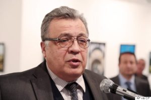 Andrei Karlov, the Russian Ambassador to Turkey, speaks at a photo exhibition in Ankara on Monday, Dec. 19, 2016, moments before a gunman opened fire on him. Karlov was rushed to a hospital after the attack and later died from his gunshot wounds. (AP Photo/Burhan Ozbilici)