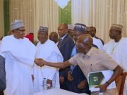 Buhari In Handshake With Oshiohole At Ministerial Retreat
